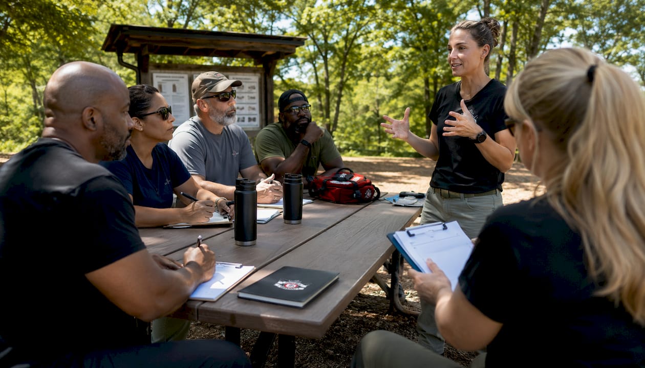 Instructor leading in-person firearm safety class in classroom