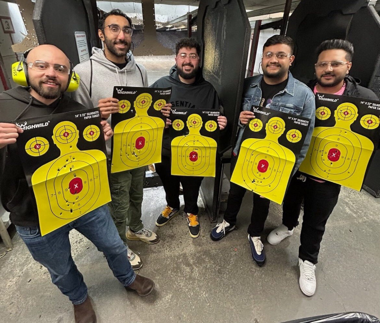 A Trouble Defense range group holding their targets after a shooting experience