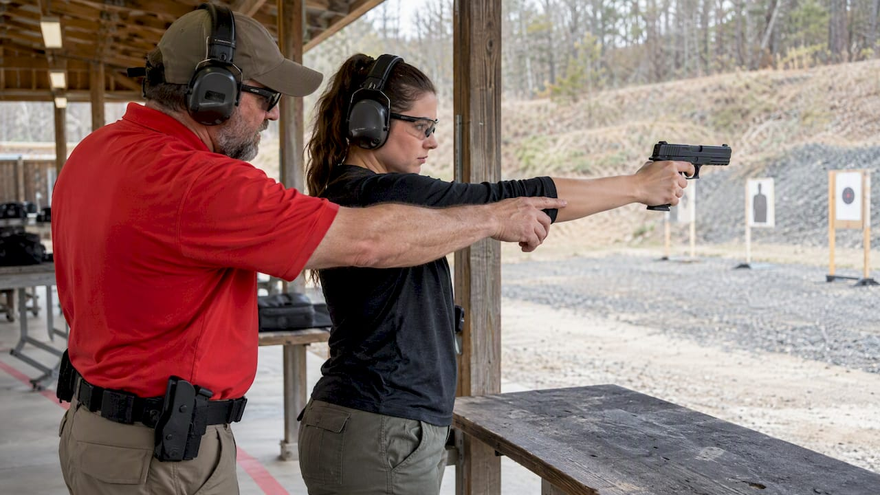 Instructor coaching supervised one-handed shooting practice