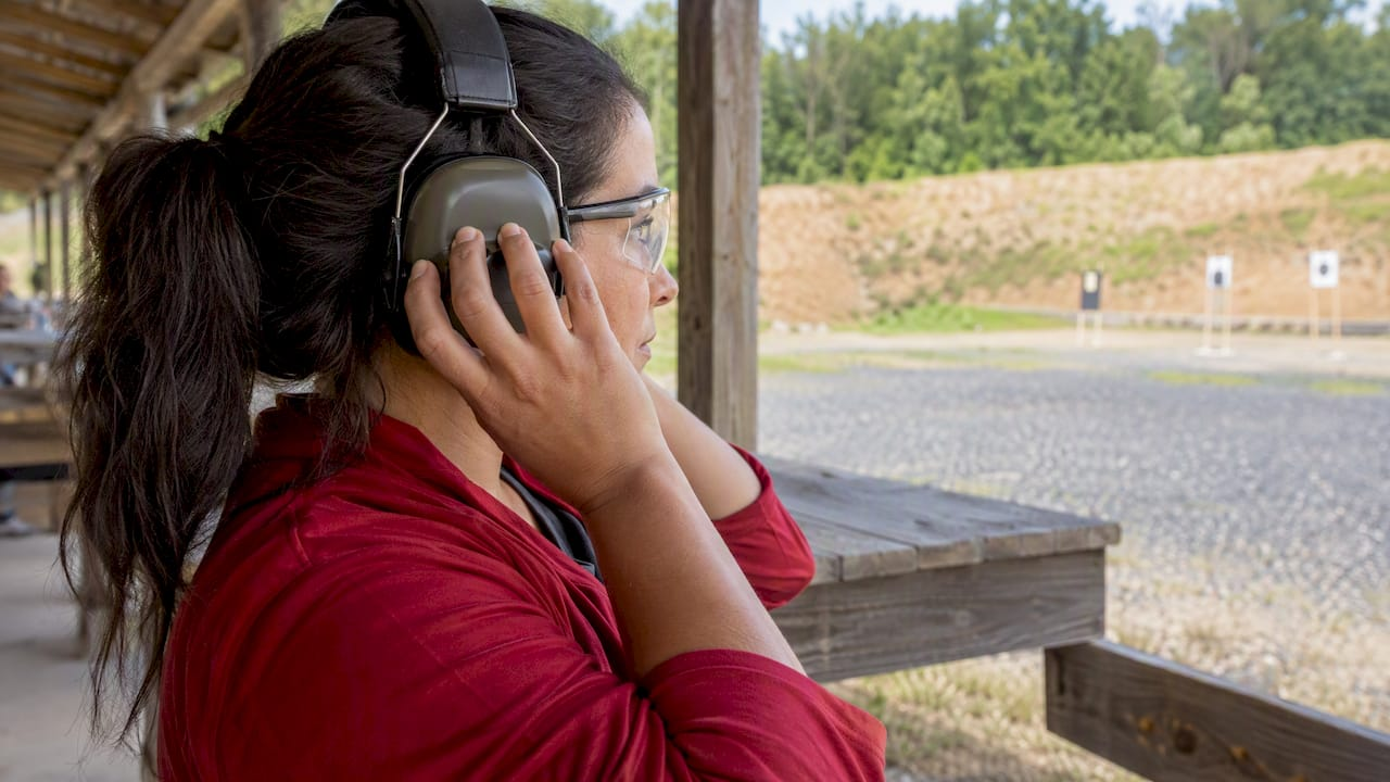 Shooter wearing foam earplugs and earmuffs