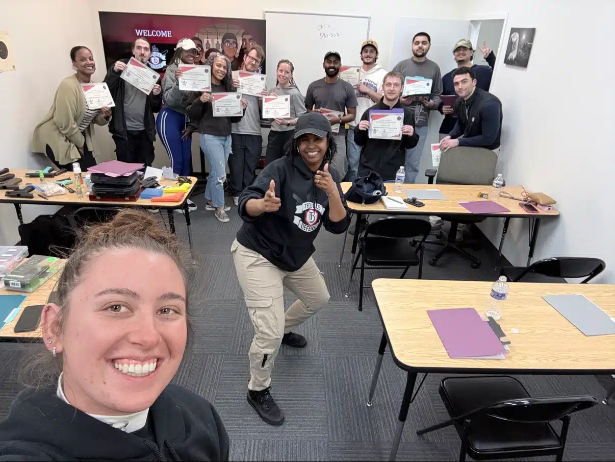 Trouble Defense firearm training graduates holding certificates in Northern Virginia